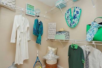 a closet with clothes and accessories hanging on the wall